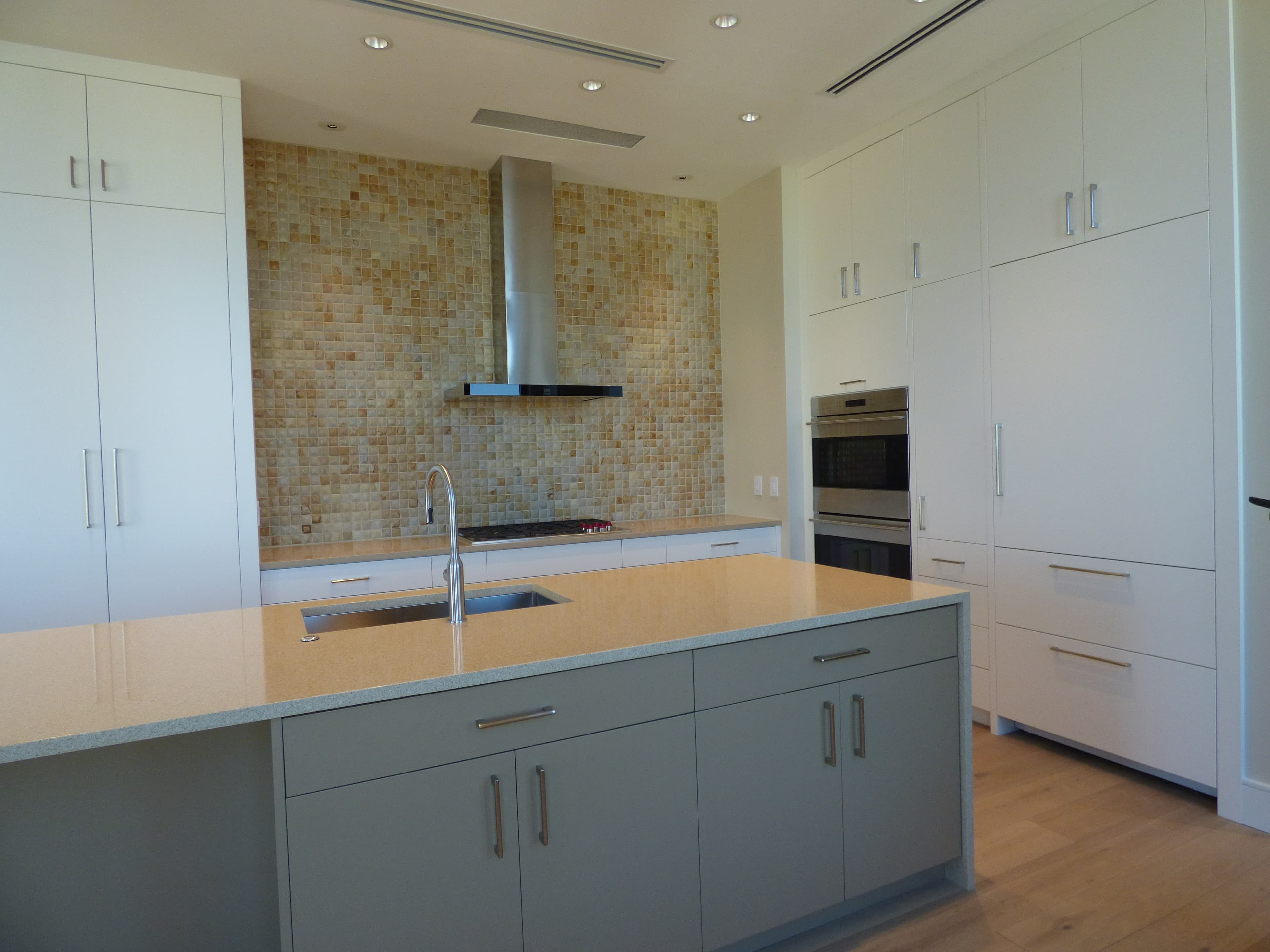 Modern kitchen remodel with flat-panel cabinets and a waterfall island by Hdez Gabinets in Atlanta